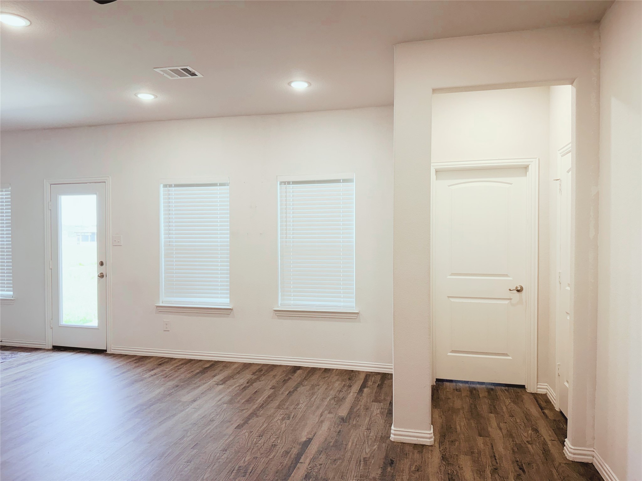 870 5102nd Road Cleveland, TX 77327 - Photo 3 of 27 an empty room with wooden floor and windows