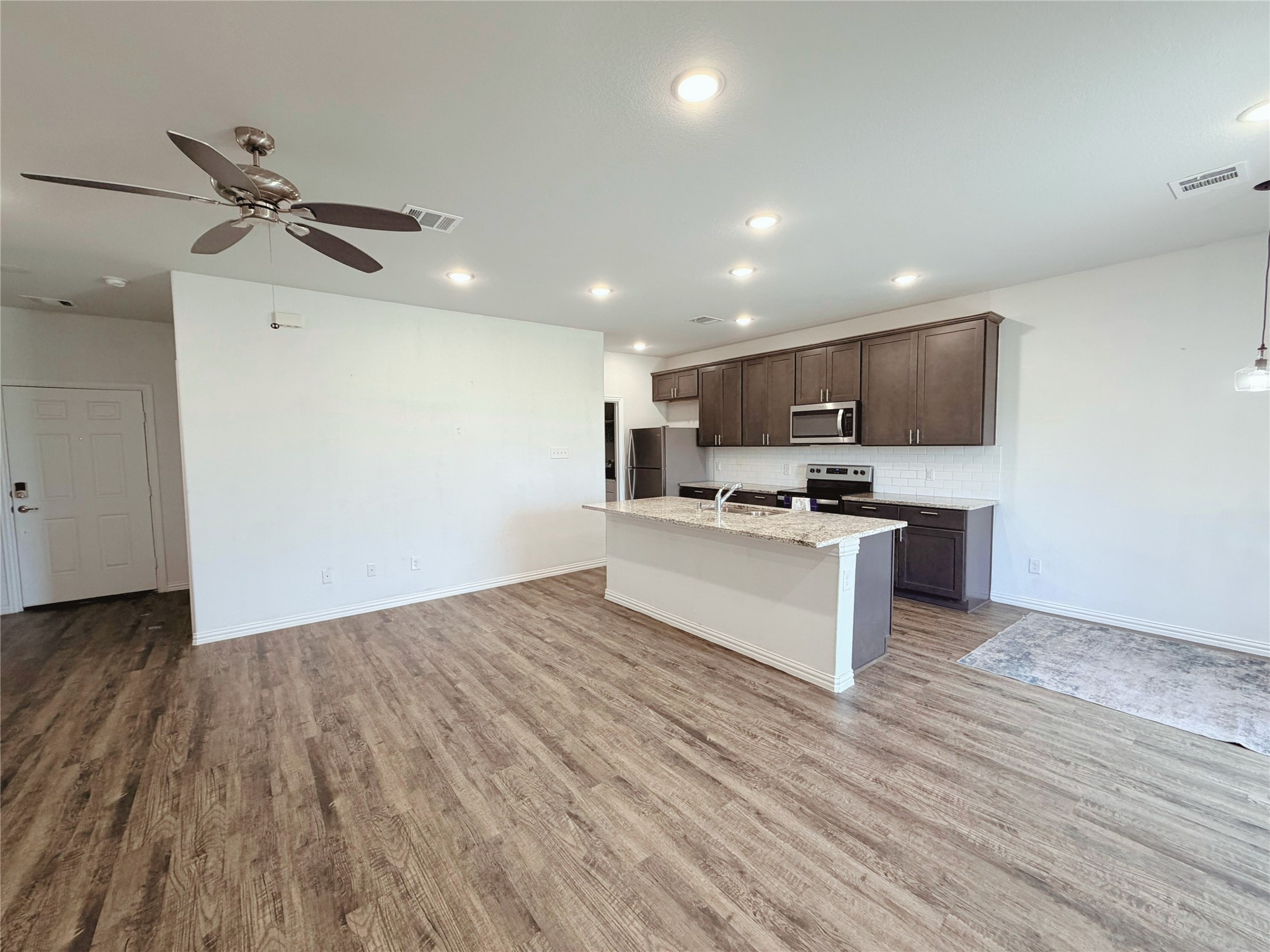 870 5102nd Road Cleveland, TX 77327 - Photo 4 of 27 a view of kitchen with granite countertop cabinets and refrigerator