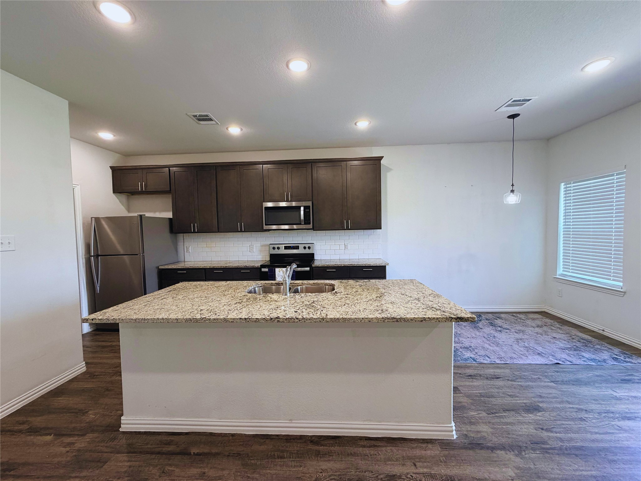 870 5102nd Road Cleveland, TX 77327 - Photo 8 of 27 a view of kitchen sink microwave and refrigerator
