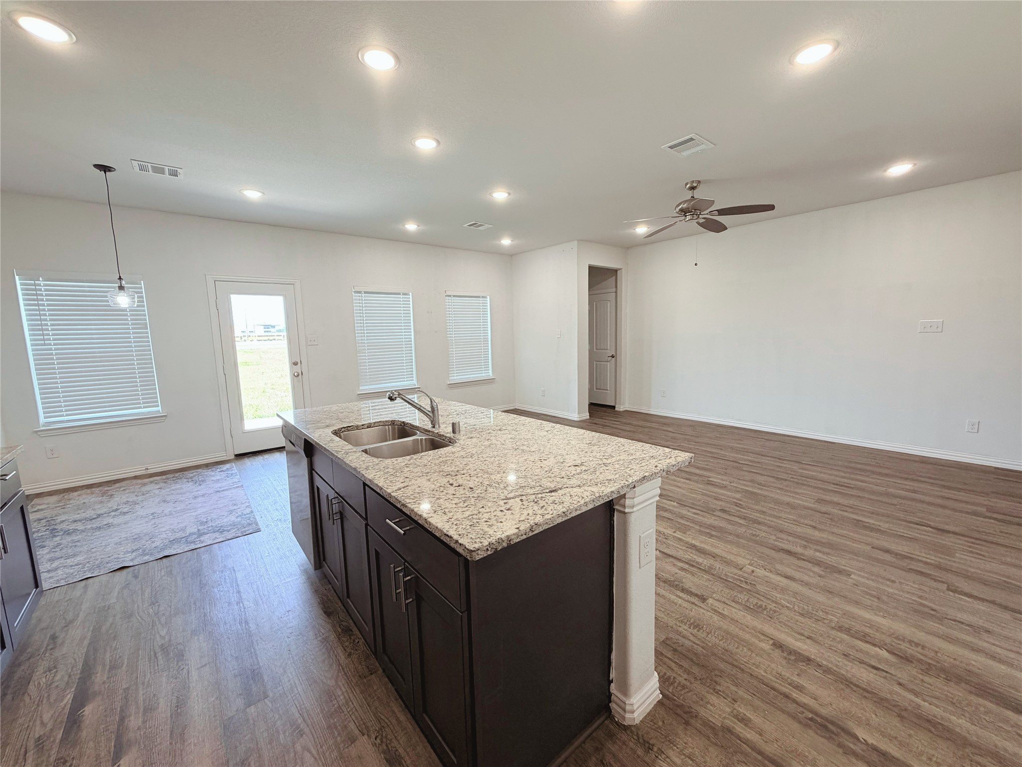 870 5102nd Road Cleveland, TX 77327 - Photo 10 of 27 a kitchen with stainless steel appliances granite countertop a sink stove and wooden floor