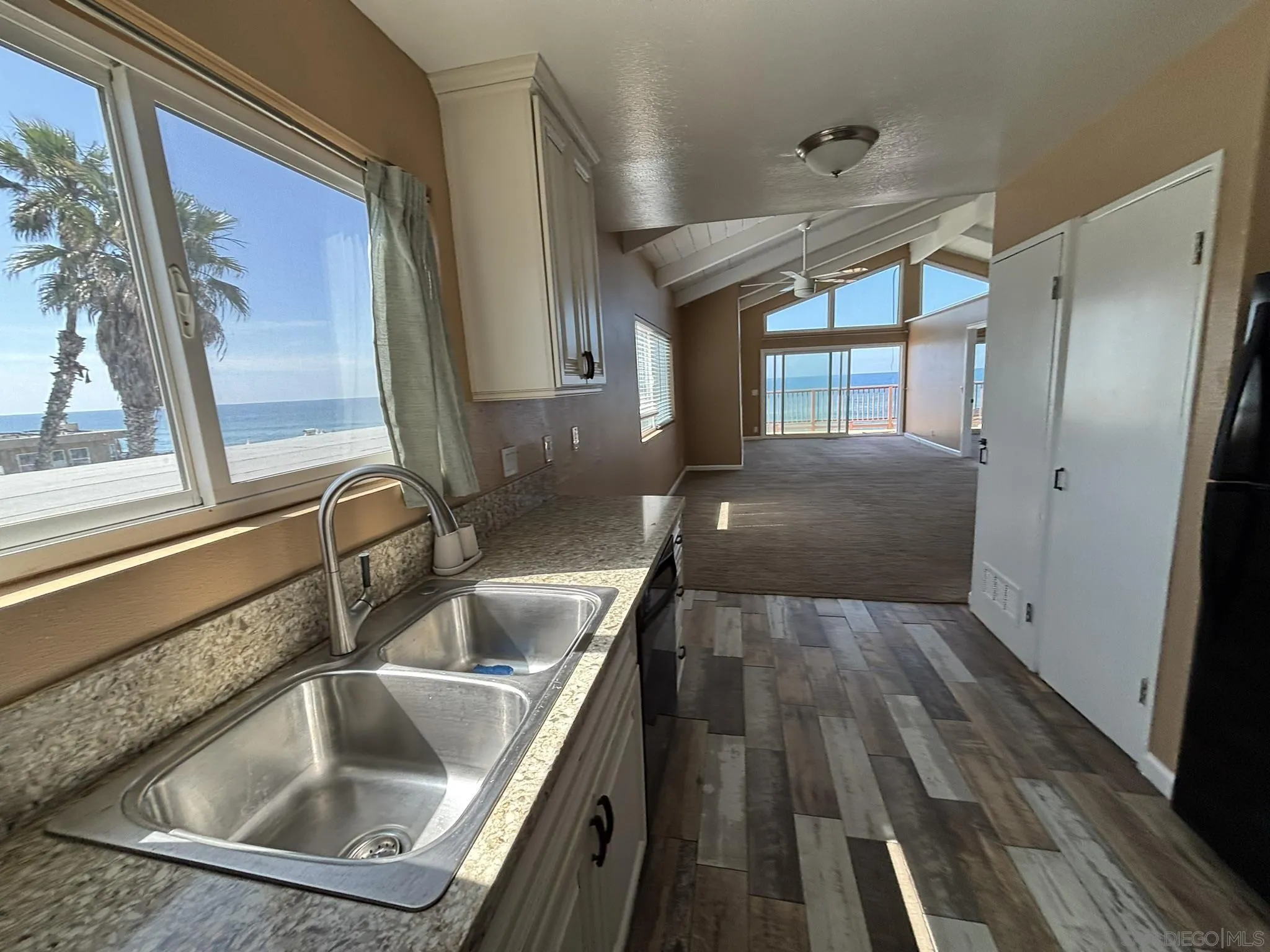 514 South The Strand, Unit D Oceanside, CA 92054 - Photo 12 of 18 a kitchen with a sink and a large window