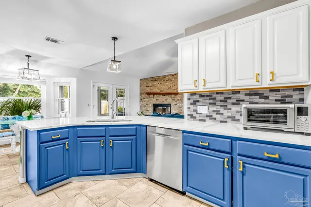 a kitchen with stainless steel appliances granite countertop a sink dishwasher stove and cabinets
