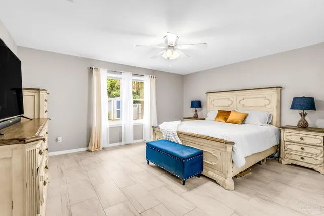 a bedroom with a bed and a flat screen tv