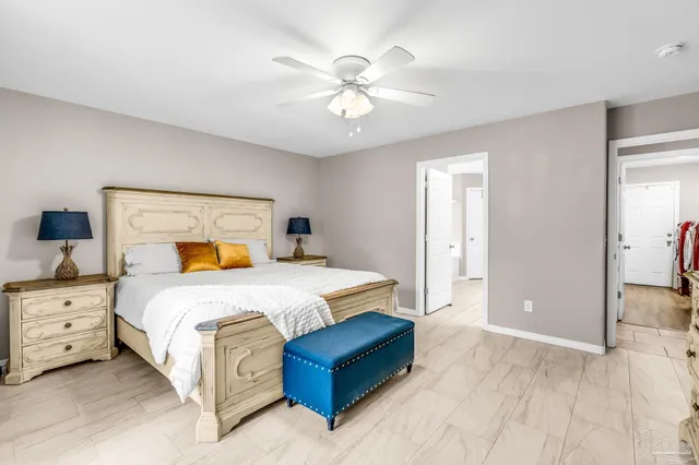 a bedroom with a large bed and a chandelier