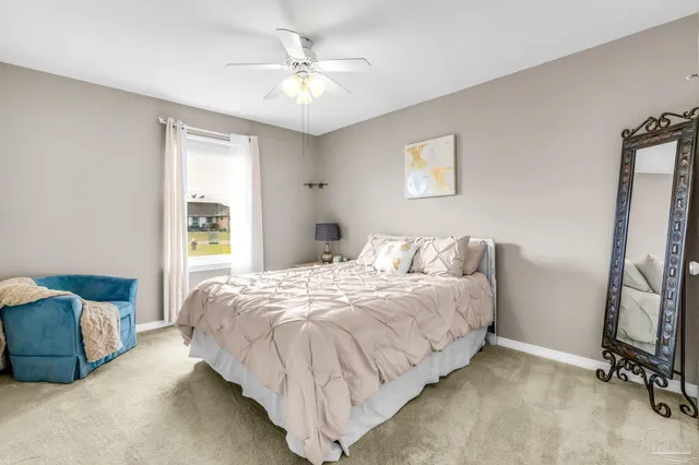 a bedroom with a bed a couch and a window