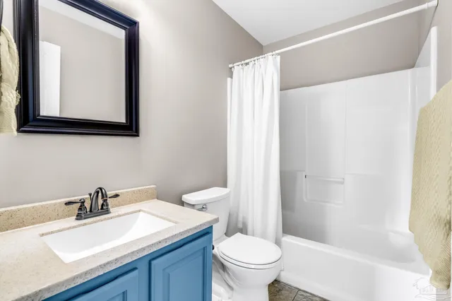 a bathroom with a sink vanity mirror and toilet