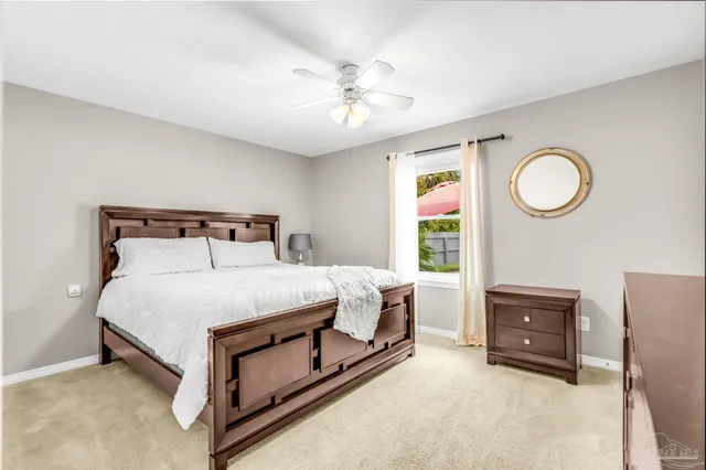 a bedroom with a bed and a fan