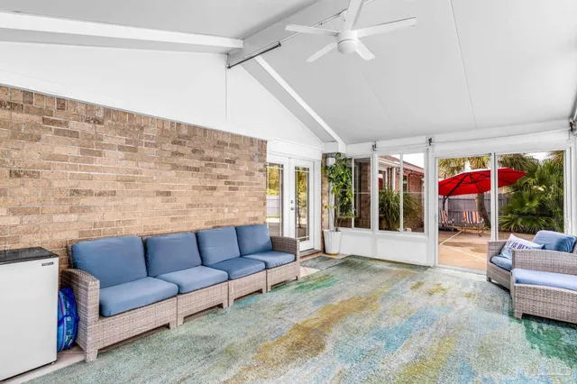 a living room with furniture and a ceiling fan