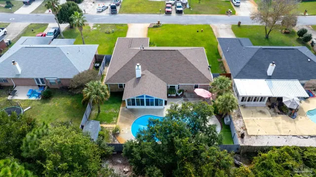an aerial view of a house with garden space and street view