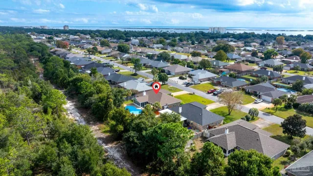 an aerial view of residential houses with swimming pool and outdoor space