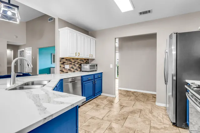 a kitchen with a sink stove and refrigerator