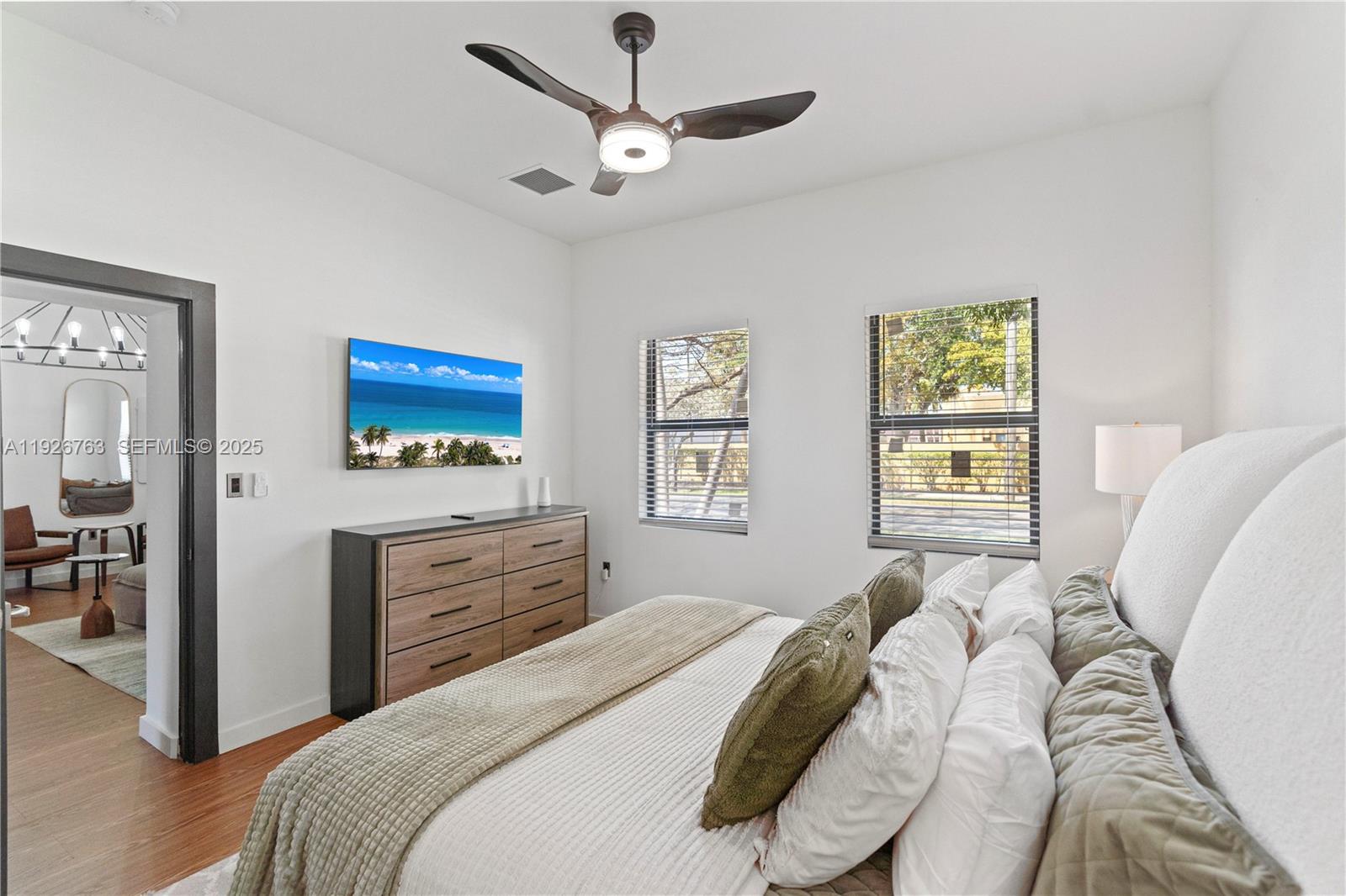 601 Southwest 1st Street Hallandale Beach, FL 33009 - Photo 21 of 33 a bedroom with a bed and a dresser with wooden floor