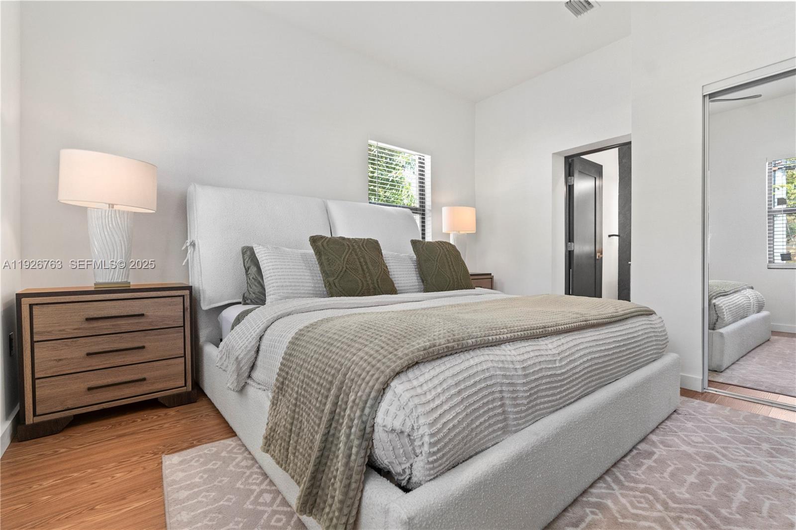 601 Southwest 1st Street Hallandale Beach, FL 33009 - Photo 22 of 33 a bedroom with a bed and a lamp