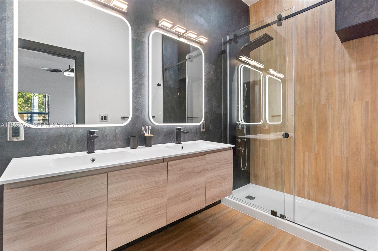 601 Southwest 1st Street Hallandale Beach, FL 33009 - Photo 26 of 33 a bathroom with a double vanity sink and mirror