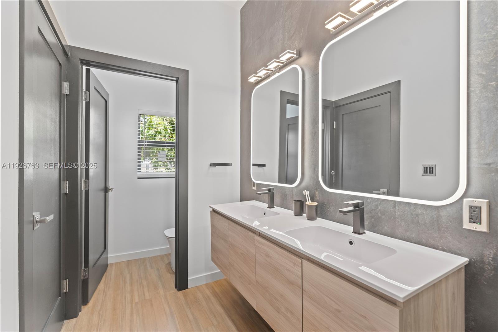 601 Southwest 1st Street Hallandale Beach, FL 33009 - Photo 27 of 33 a bathroom with a double vanity sink mirror and