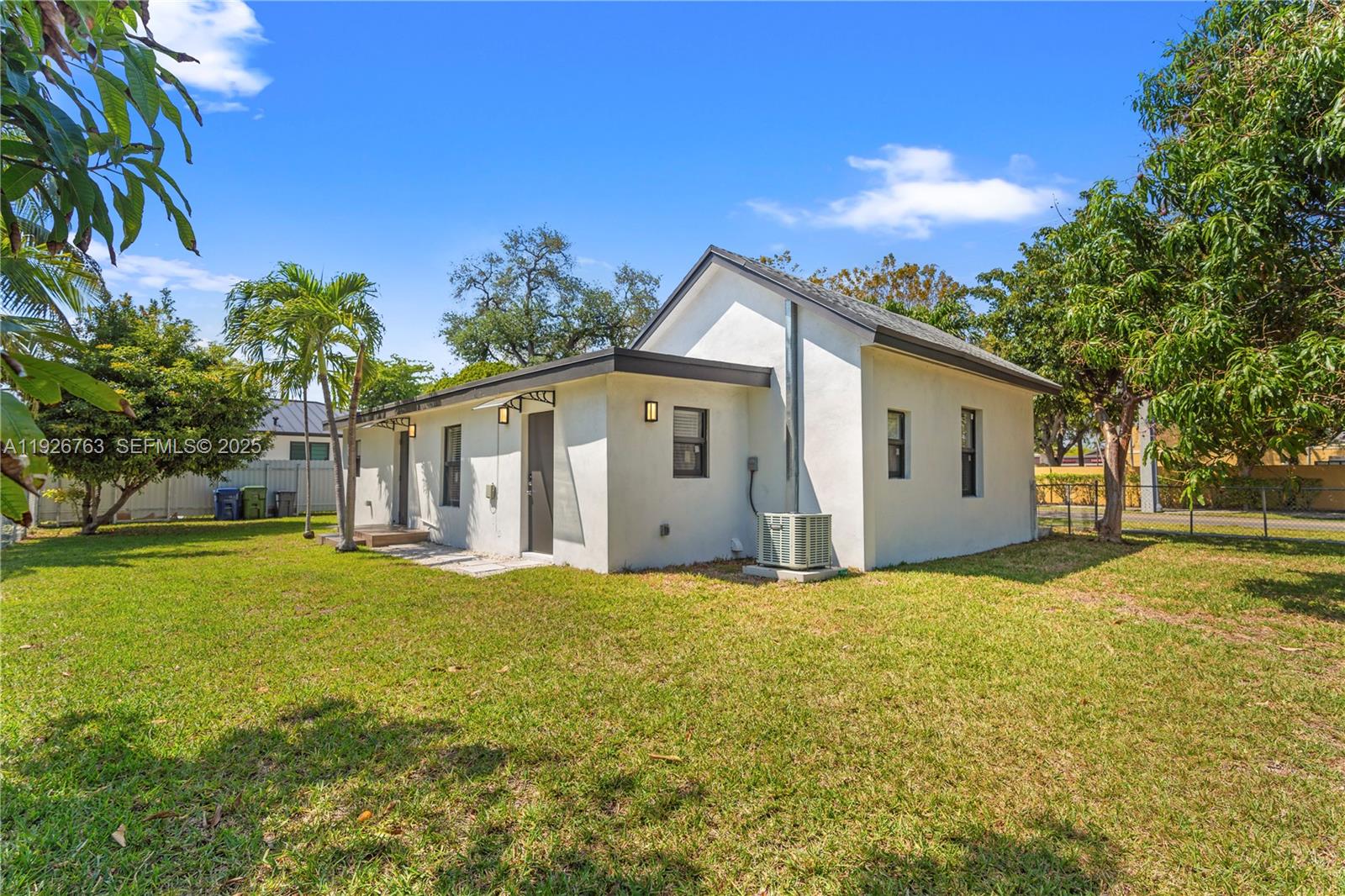 601 Southwest 1st Street Hallandale Beach, FL 33009 - Photo 31 of 33 a view of a house with a yard and garage