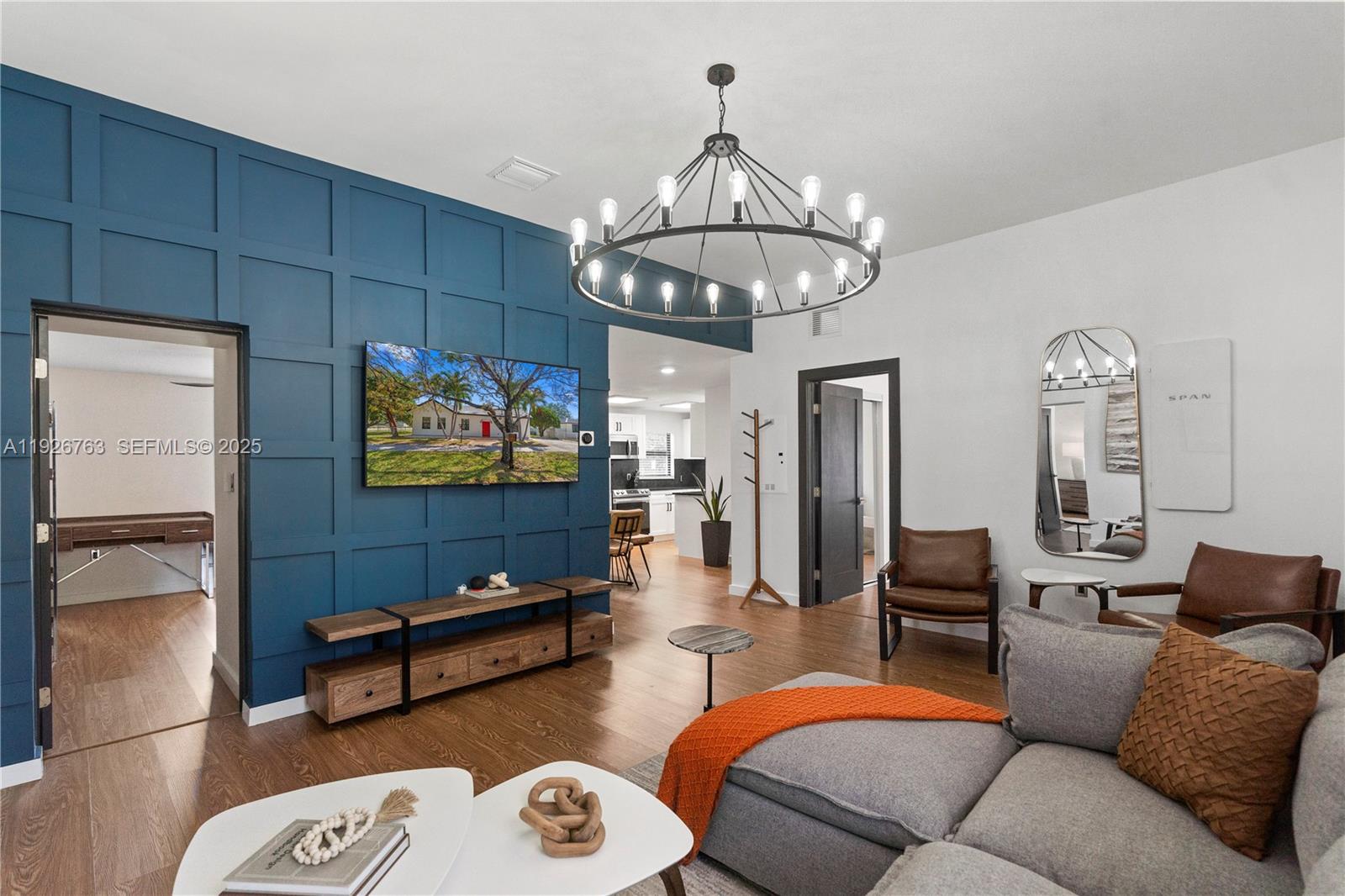 601 Southwest 1st Street Hallandale Beach, FL 33009 - Photo 6 of 33 a living room with furniture a chandelier and kitchen view