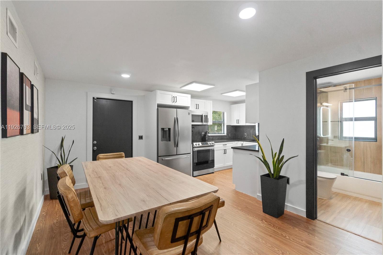 601 Southwest 1st Street Hallandale Beach, FL 33009 - Photo 10 of 33 a kitchen with a table and chairs in it