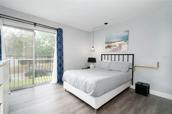 a bedroom with a bed and a large window