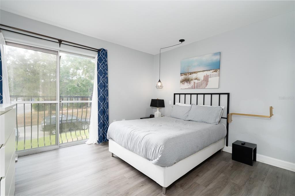 1700 Southwest 16th Court, Unit C25 Gainesville, FL 32608 - Photo 11 of 22 a bedroom with a bed and a large window
