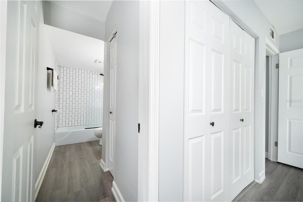 1700 Southwest 16th Court, Unit C25 Gainesville, FL 32608 - Photo 13 of 22 a view of a hallway with wooden floor and closet area