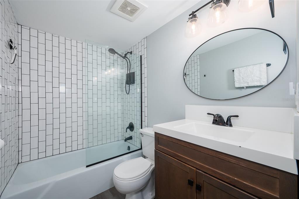 1700 Southwest 16th Court, Unit C25 Gainesville, FL 32608 - Photo 14 of 22 a bathroom with a sink a toilet and a mirror