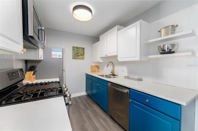 a kitchen with stainless steel appliances a sink and a stove