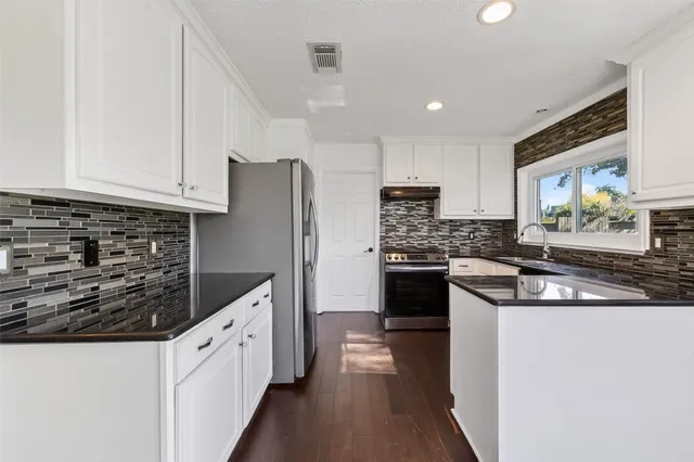 a kitchen with a stove and a sink