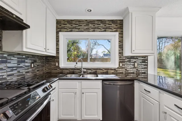 a kitchen with a stove and a sink