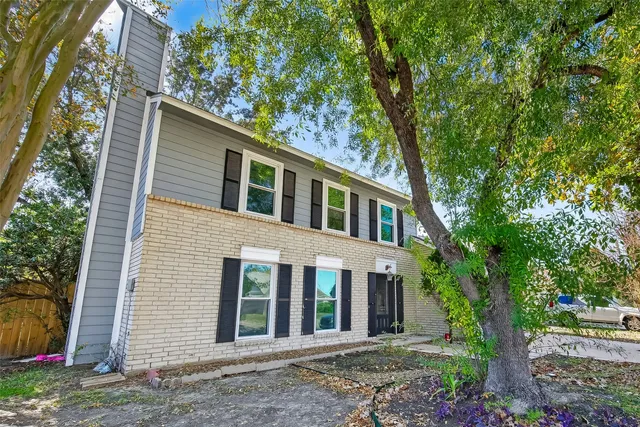 front view of a house with a tree
