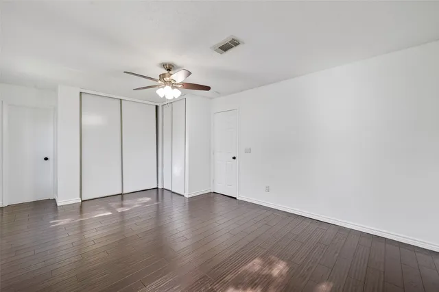 a bathroom with a granite countertop sink a toilet a mirror and shower