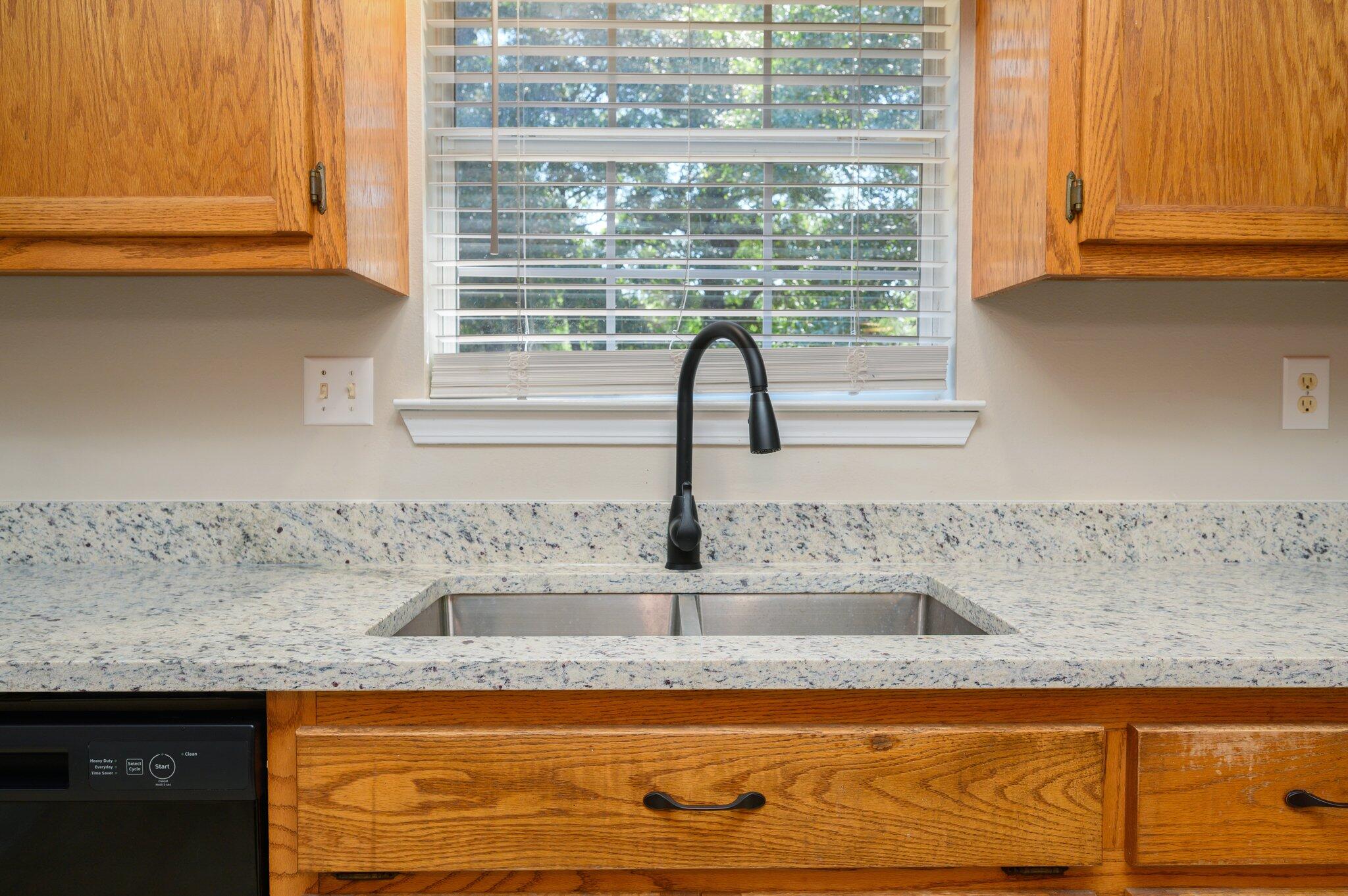 502 Hyde Park Drive Crestview, FL 32539 - Photo 14 of 35 a kitchen with granite countertop a sink and a window