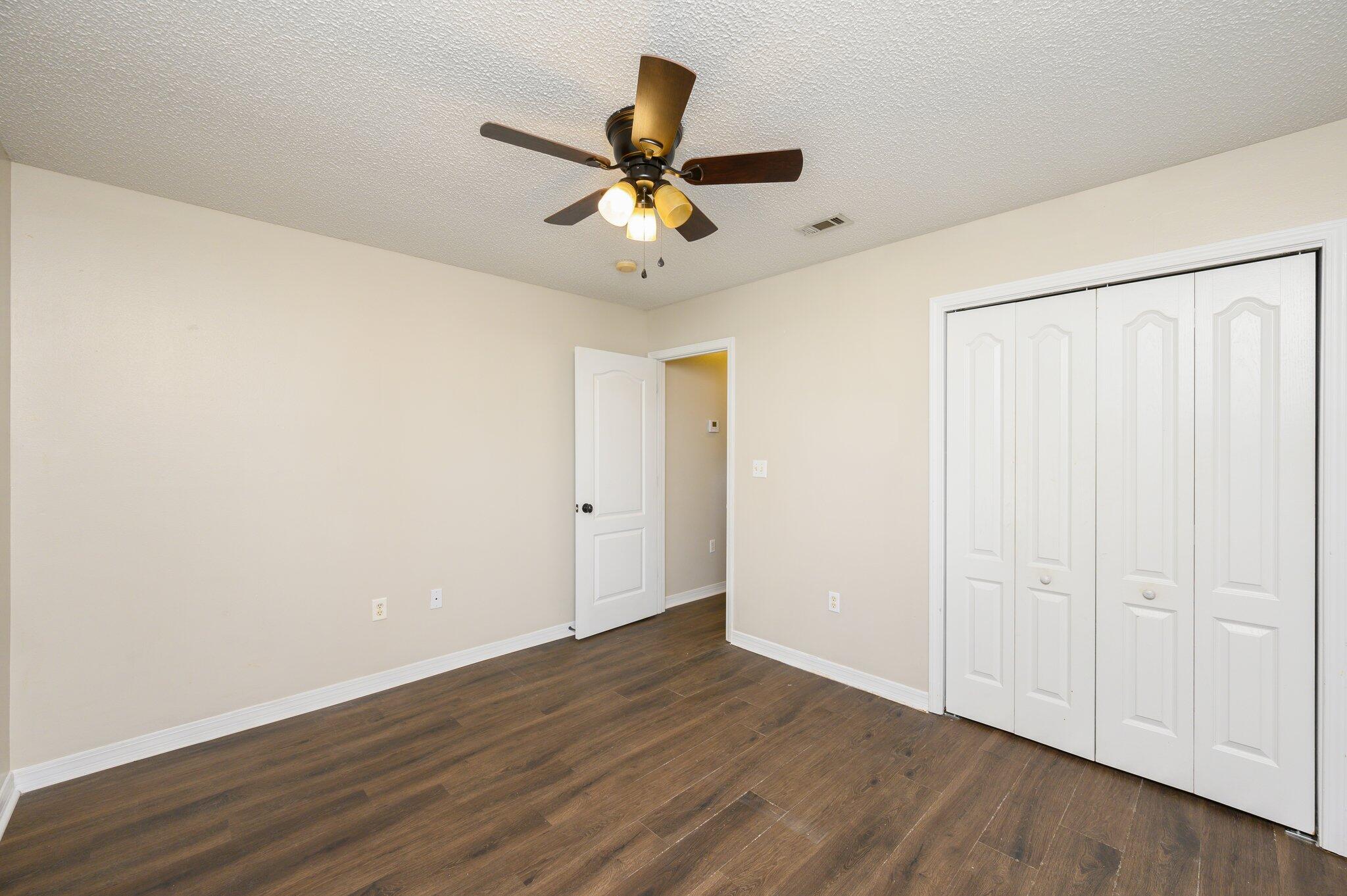 502 Hyde Park Drive Crestview, FL 32539 - Photo 17 of 35 a view of an empty room with wooden floor