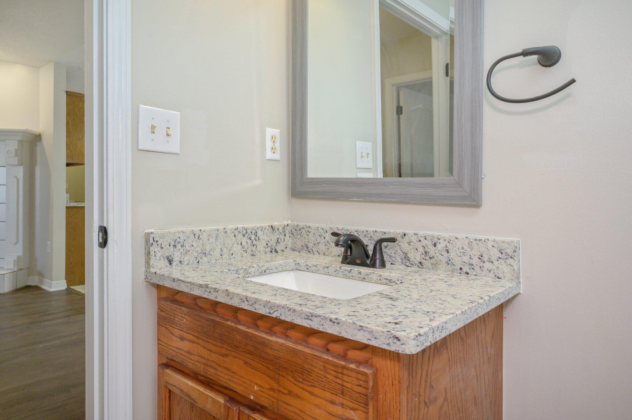 502 Hyde Park Drive Crestview, FL 32539 - Photo 21 of 35 a bathroom with a granite countertop sink and a mirror