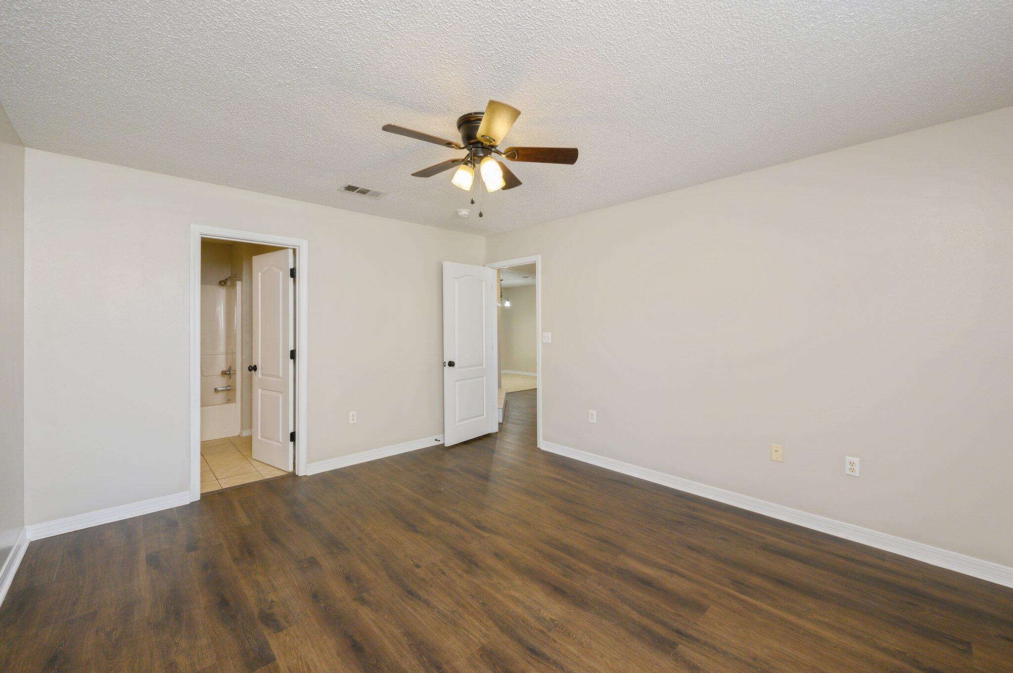 502 Hyde Park Drive Crestview, FL 32539 - Photo 25 of 35 a view of a room with wooden floor and a ceiling fan