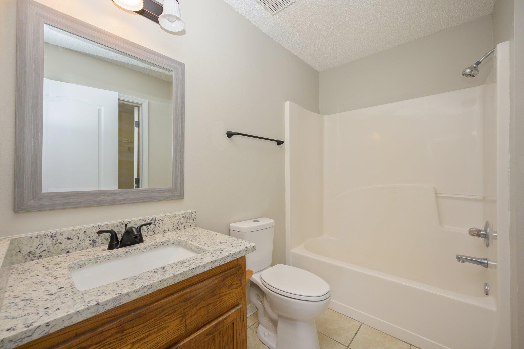 502 Hyde Park Drive Crestview, FL 32539 - Photo 26 of 35 a bathroom with a granite countertop sink toilet and shower