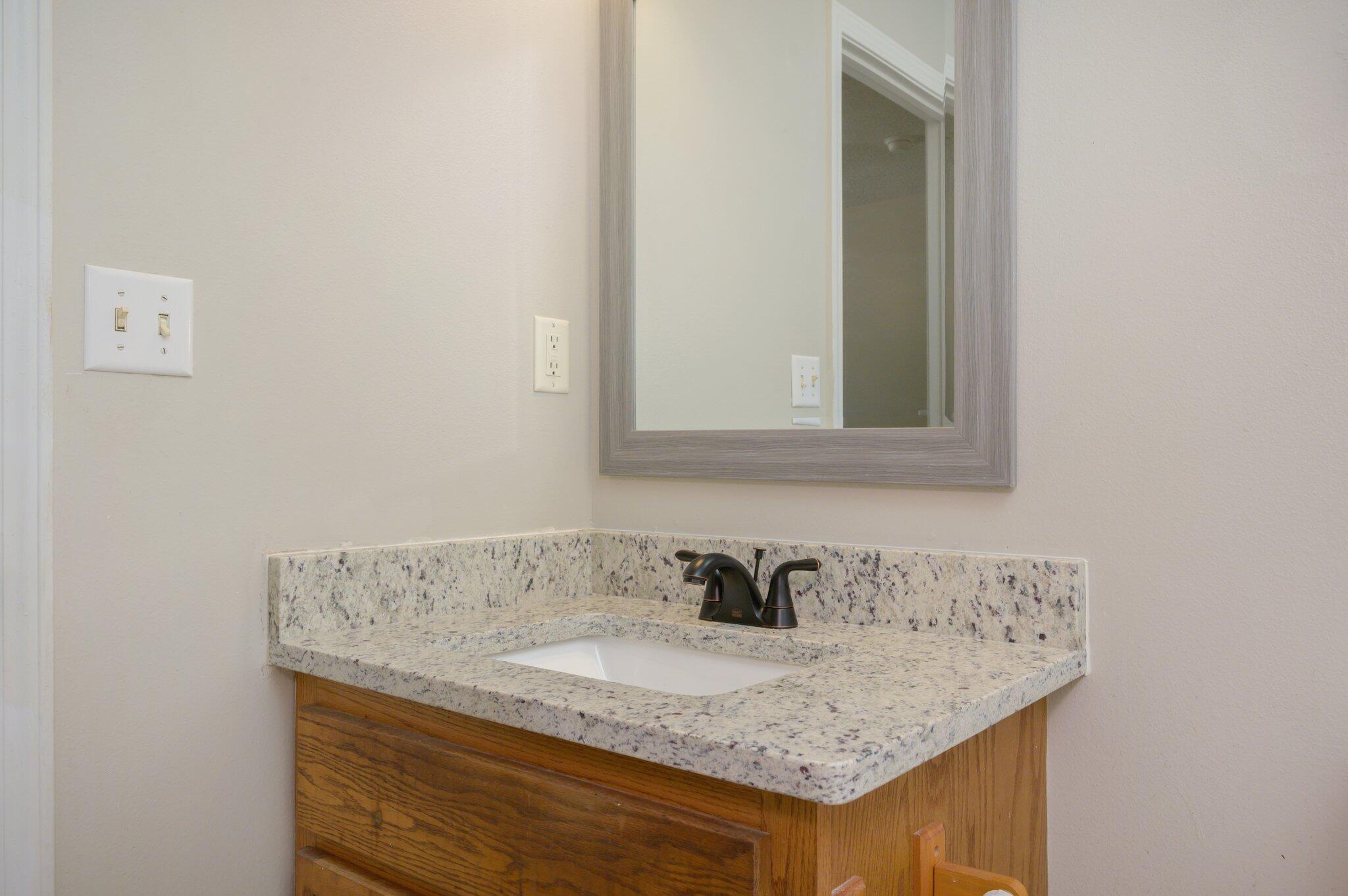 502 Hyde Park Drive Crestview, FL 32539 - Photo 27 of 35 a bathroom with a granite countertop sink and a mirror