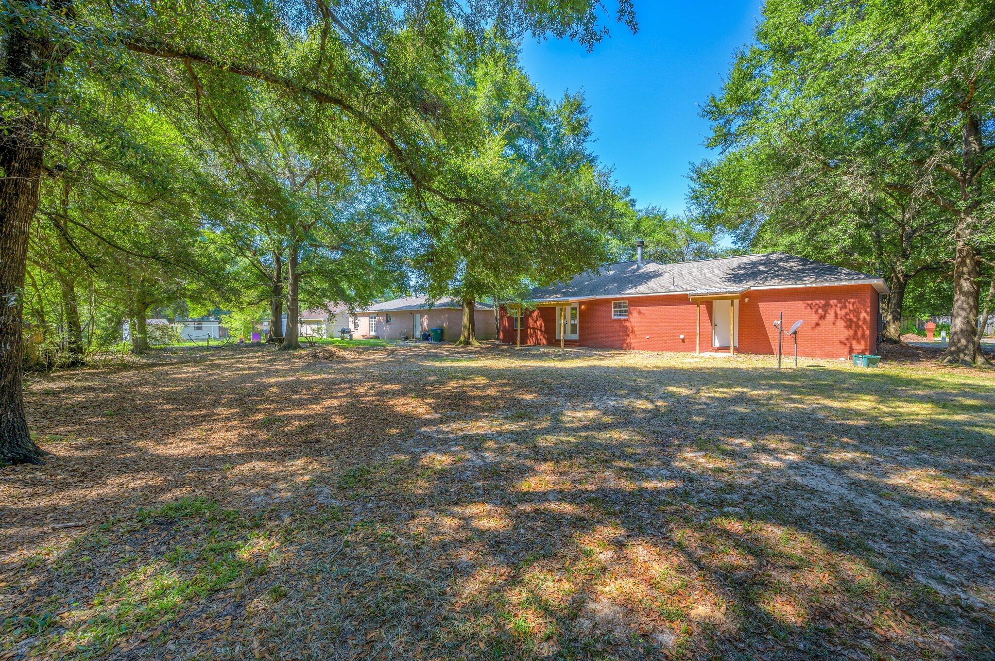 502 Hyde Park Drive Crestview, FL 32539 - Photo 33 of 35 a backyard of a house with barbeque oven table and chairs