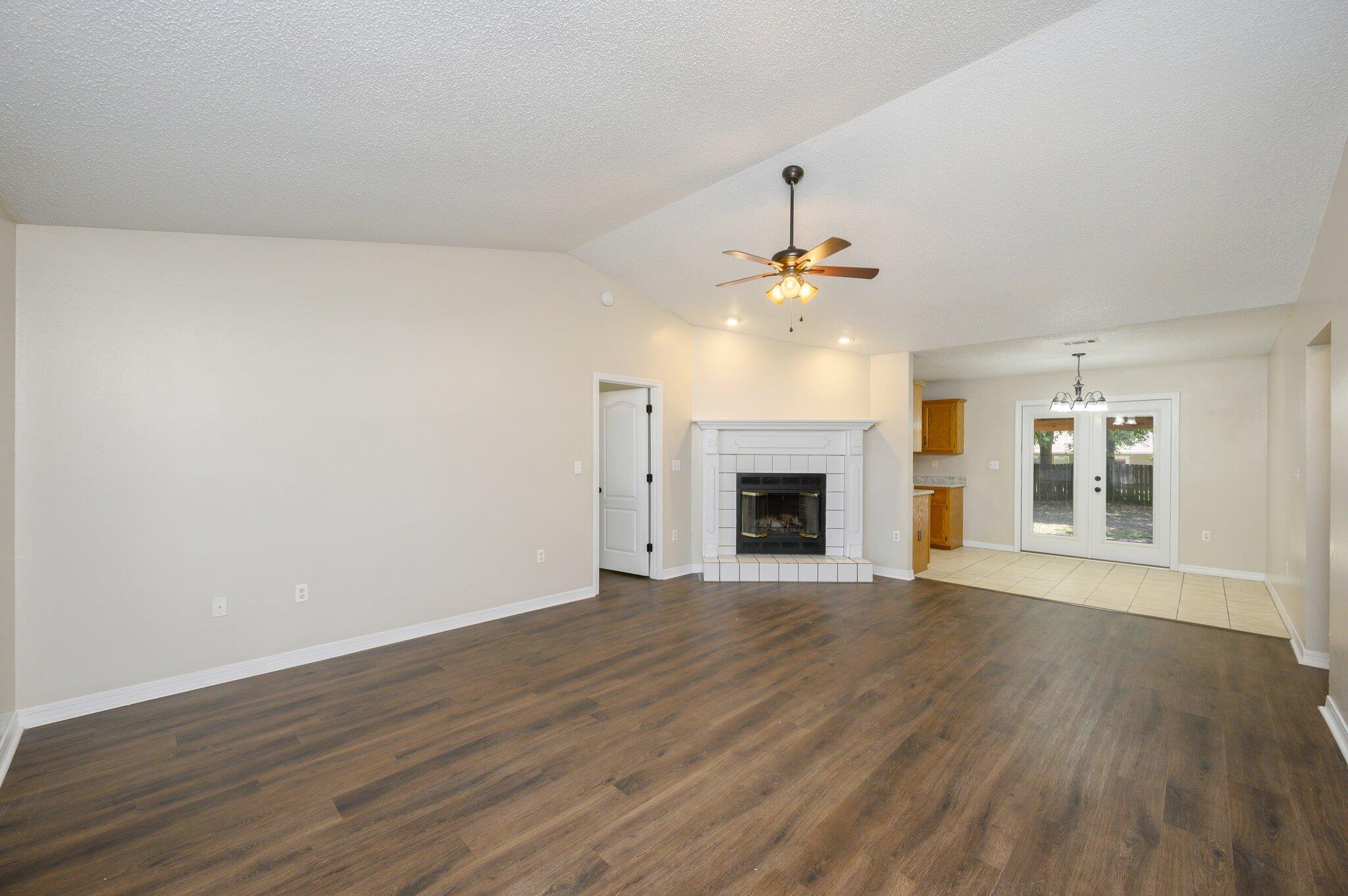 502 Hyde Park Drive Crestview, FL 32539 - Photo 6 of 35 a view of an empty room with wooden floor and fireplace