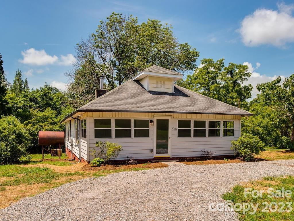 2589 Fay Jones Road Denver, NC 28037 - Photo 1 of 15 a front view of a house with a garden and trees
