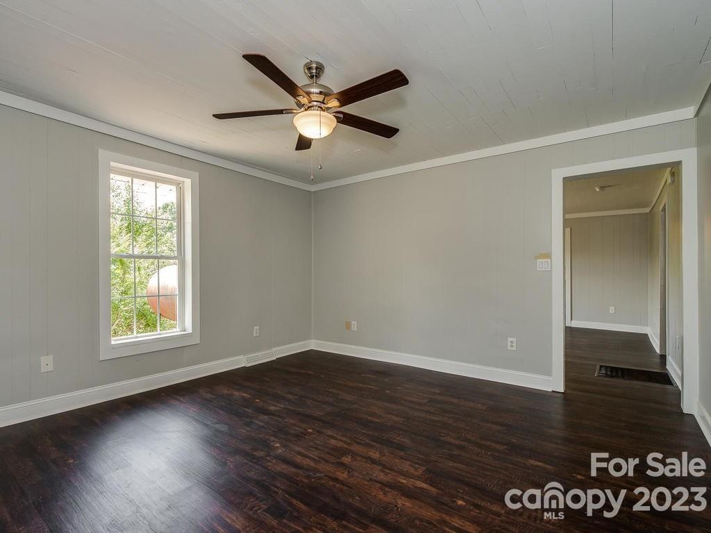 2589 Fay Jones Road Denver, NC 28037 - Photo 13 of 15 an empty room with wooden floor fan and windows