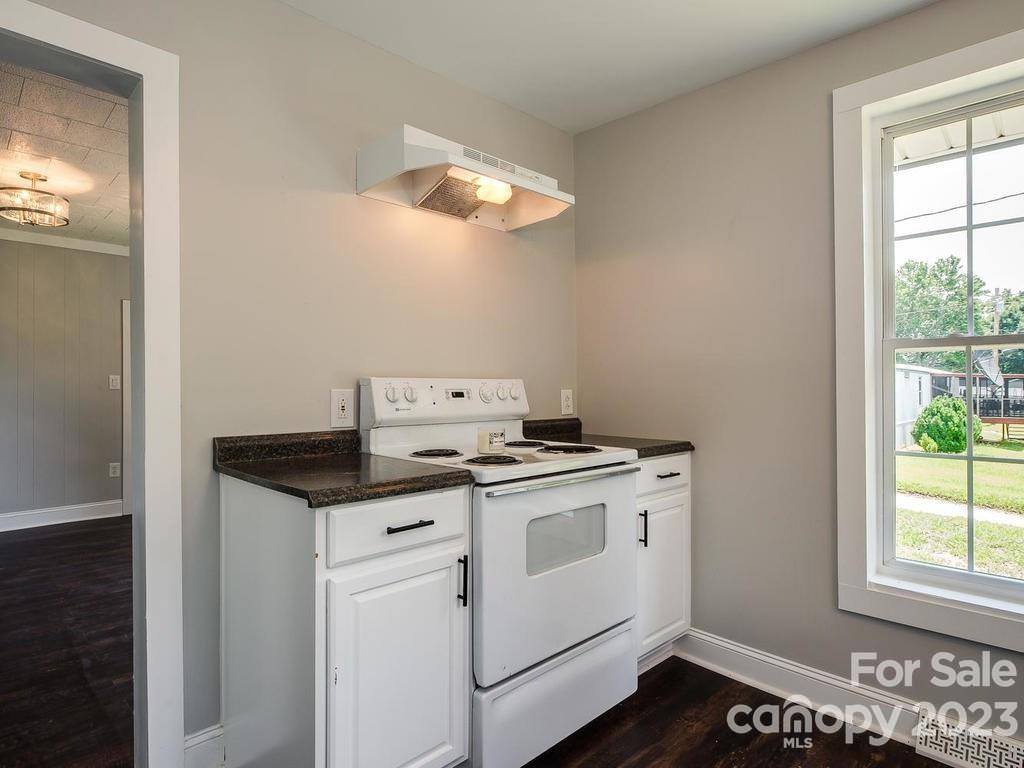 2589 Fay Jones Road Denver, NC 28037 - Photo 5 of 15 a kitchen with a stove and a wooden floor