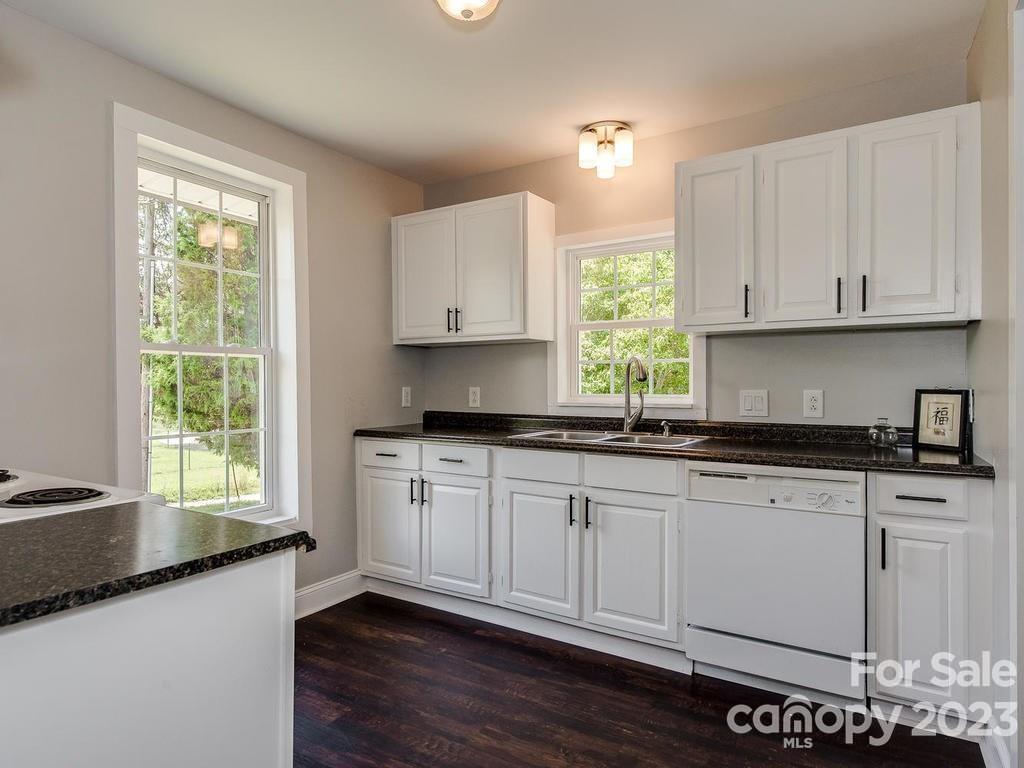 2589 Fay Jones Road Denver, NC 28037 - Photo 6 of 15 a kitchen with granite countertop a sink window and cabinets