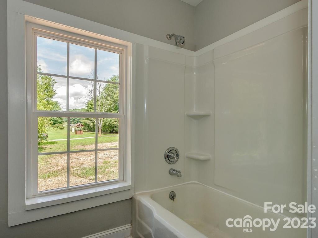 2589 Fay Jones Road Denver, NC 28037 - Photo 9 of 15 a bathroom with a bathtub and window