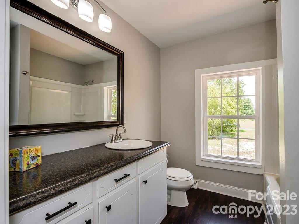 2589 Fay Jones Road Denver, NC 28037 - Photo 10 of 15 a bathroom with a toilet a sink and mirror