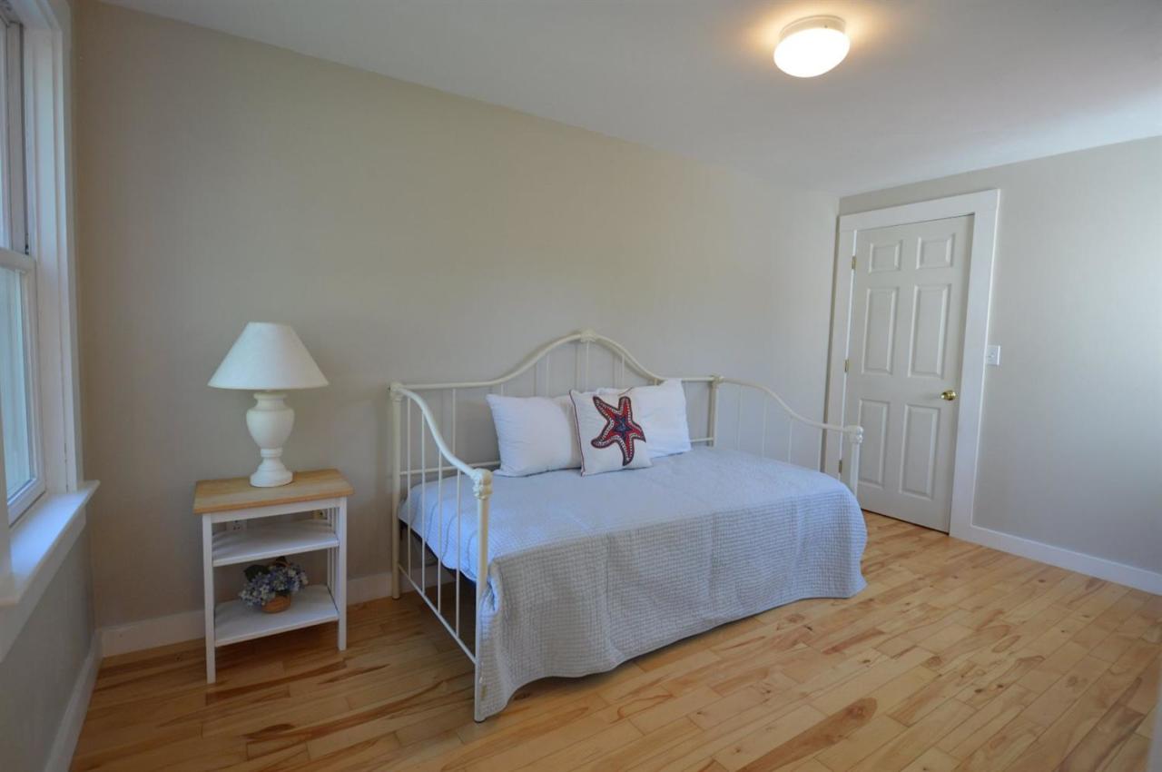 20 Sunset Lane Barnstable, MA 02630 - Photo 11 of 19 a bedroom with a bed and a lamp on table