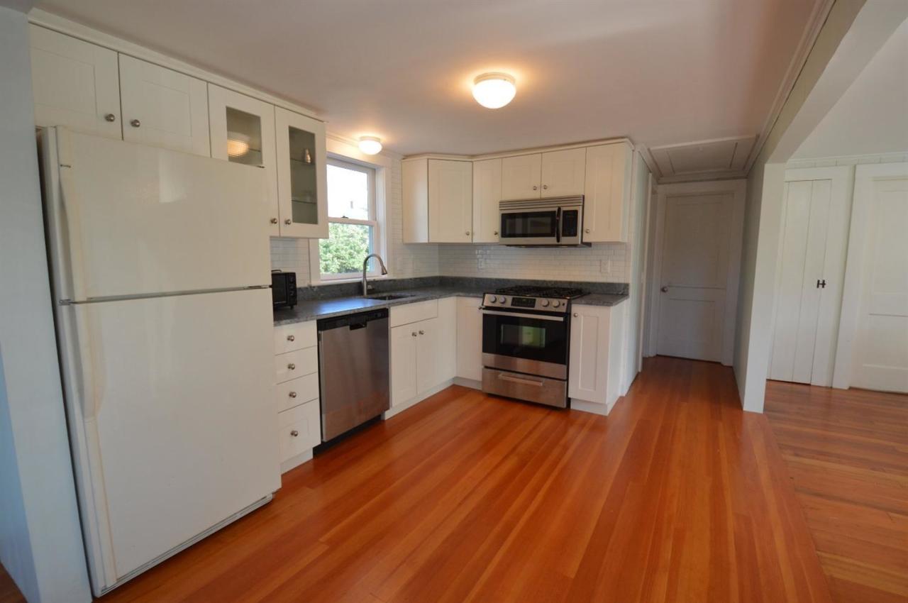 20 Sunset Lane Barnstable, MA 02630 - Photo 7 of 19 a kitchen with a refrigerator a stove top oven a sink dishwasher and wooden floor