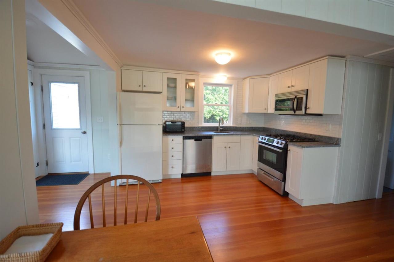 20 Sunset Lane Barnstable, MA 02630 - Photo 8 of 19 a kitchen with stainless steel appliances granite countertop a stove top oven a sink a dining table and chairs