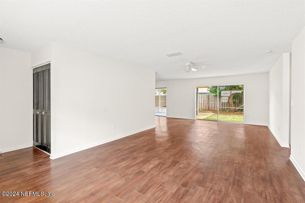 968 Espinado Avenue St. Augustine, FL 32086 - Photo 13 of 36 an empty room with wooden floor and windows