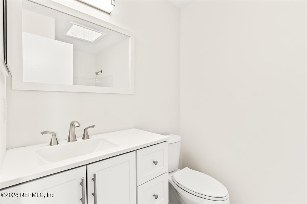 968 Espinado Avenue St. Augustine, FL 32086 - Photo 16 of 36 a bathroom with a sink a toilet and vanity